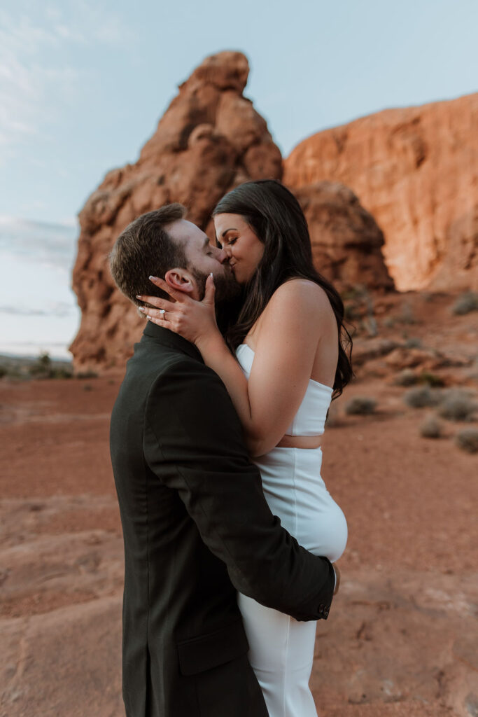 couple kisses at Arches National Park elopement