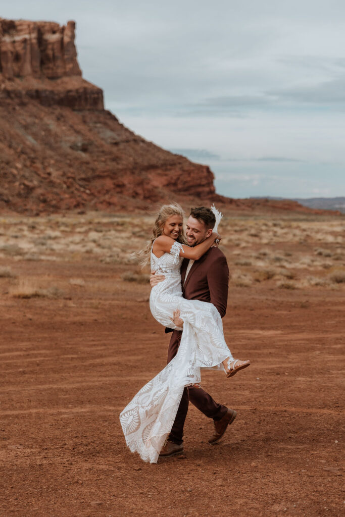 groom carries bride at The Red Earth Venue wedding