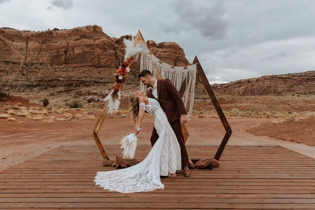 couple embraces at Moab boho elopement