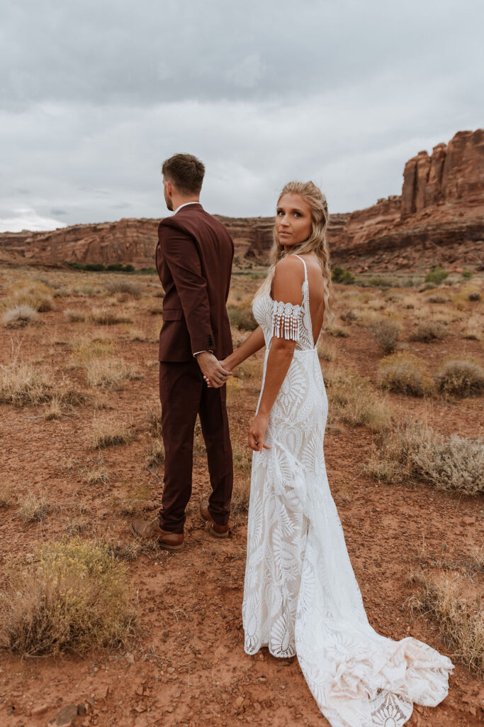 couple holds hands at The Red Earth Venue wedding