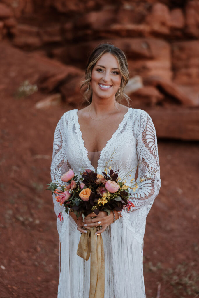 bride holds wedding bouquet at red rock elopement