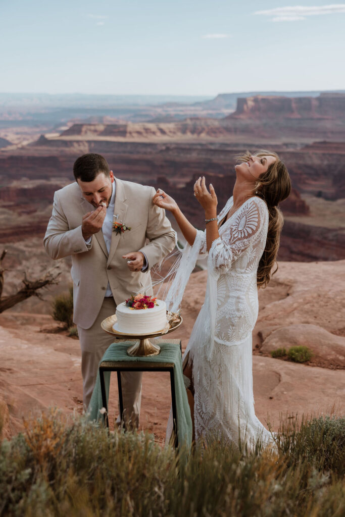 couple eats cake at Dead Horse Point State Park Moab elopement