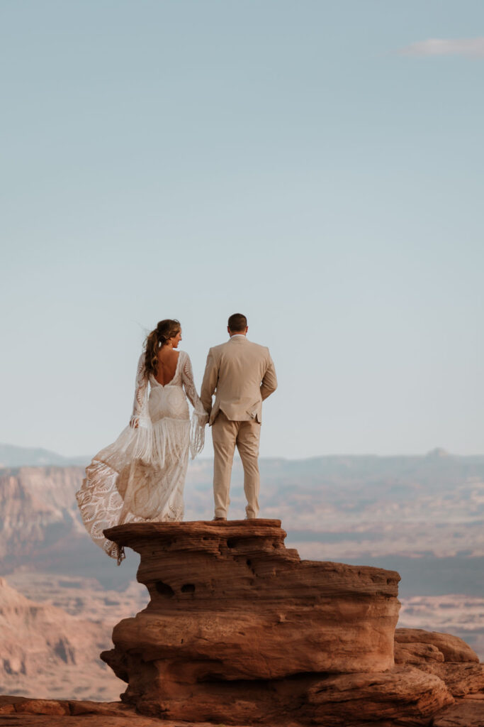 couple stands on overlook at Dead Horse Point State Park Moab elopement