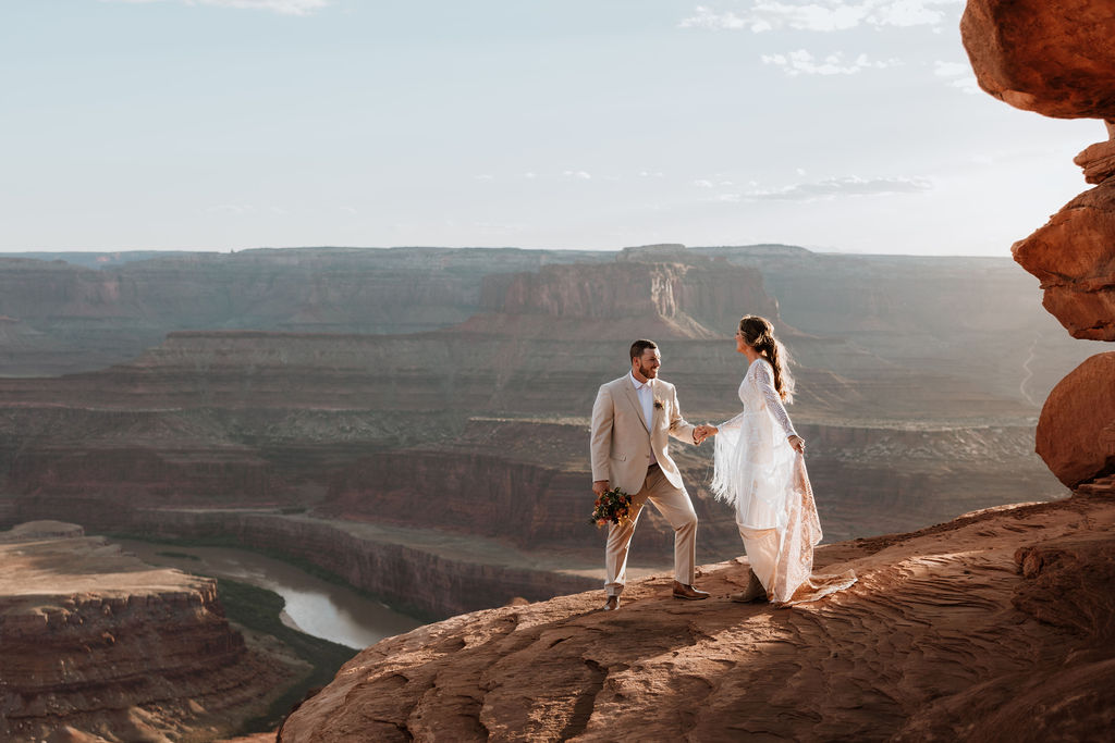 couple holds hands at Dead Horse Point State Park Moab elopement
