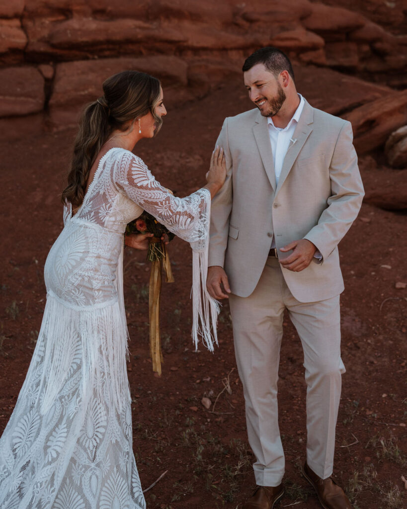 bride and groom laugh during first look at Dead Horse Point State Park Moab elopement
