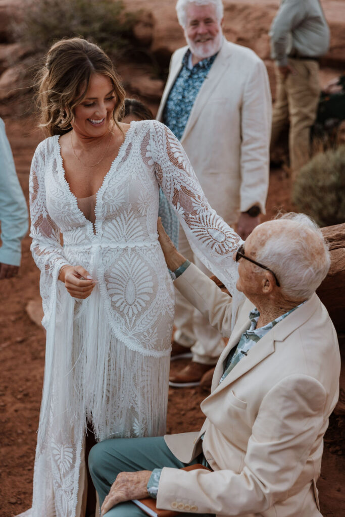 bride poses with grandpa at Moab elopement