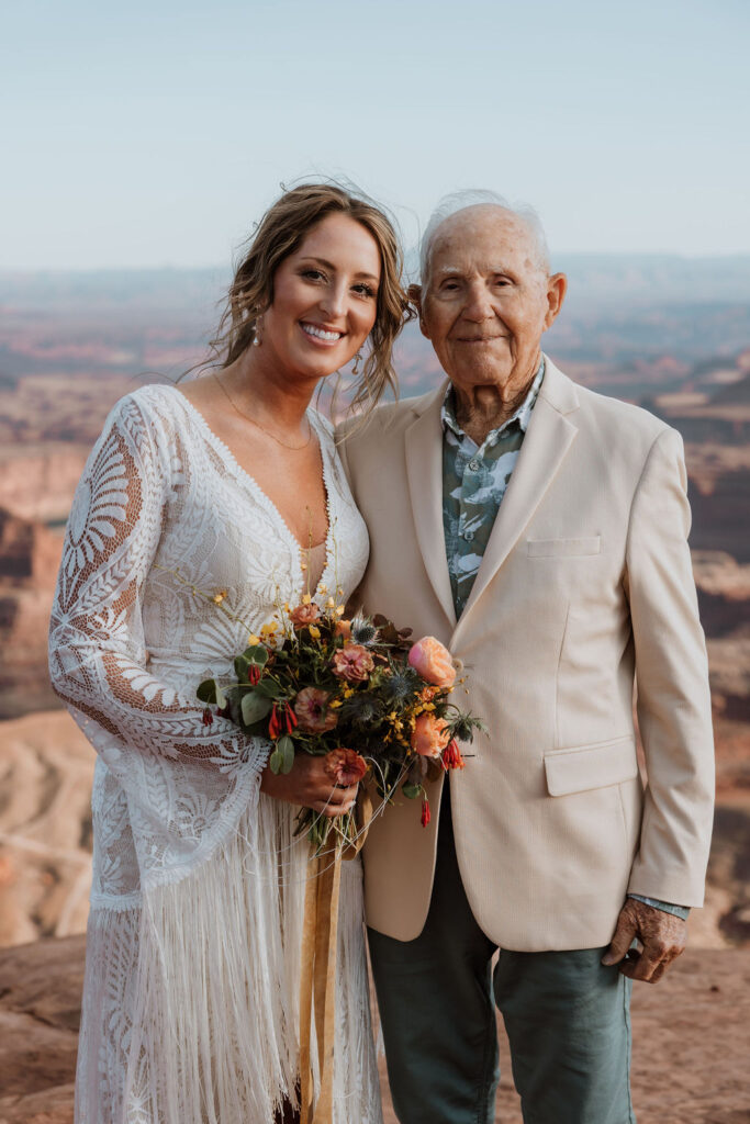 bride poses with grandpa at Moab elopement