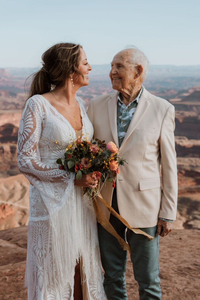 bride poses with grandpa at Moab elopement