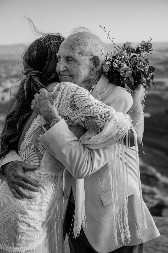 bride hugs grandpa at Moab elopement 