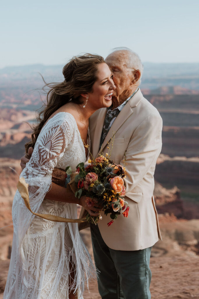 bride poses with grandpa at Moab elopement