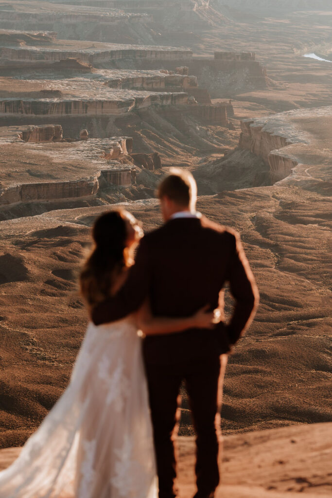 couple embraces at Canyonlands National Park elopement