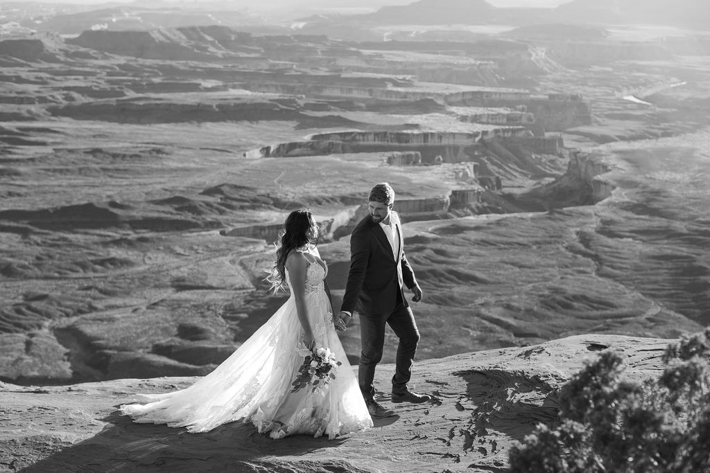 couple walks together at Canyonlands National Park elopement