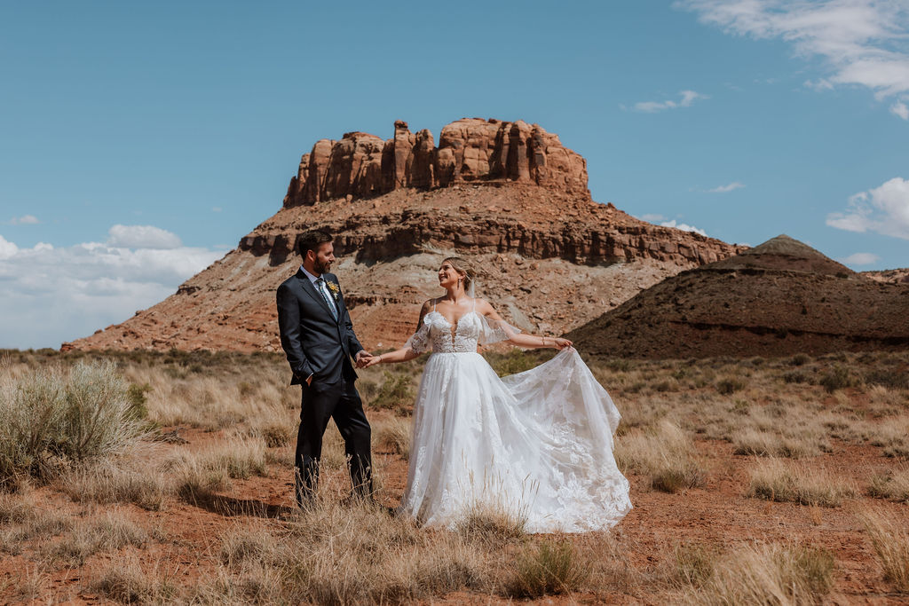 couple holds hands in Moab desert