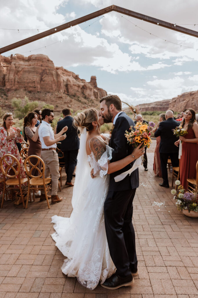 couple kisses at wedding ceremony