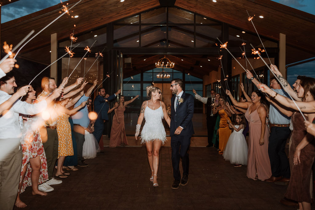 couple exits under sparklers at Moab wedding venue