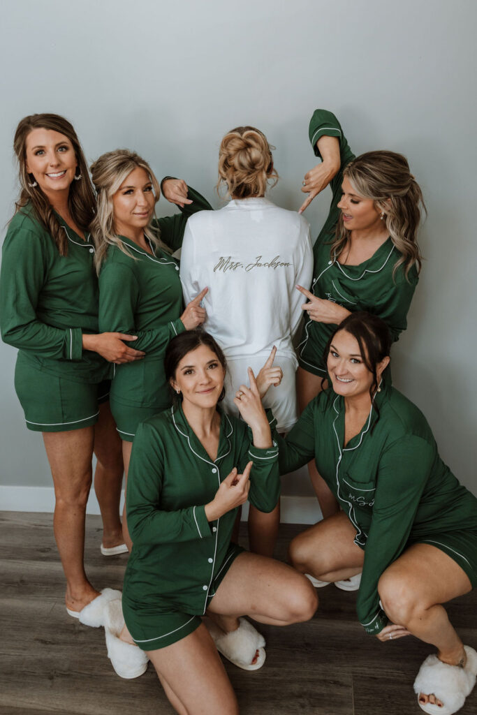 bridesmaids point to bride at wedding getting ready 