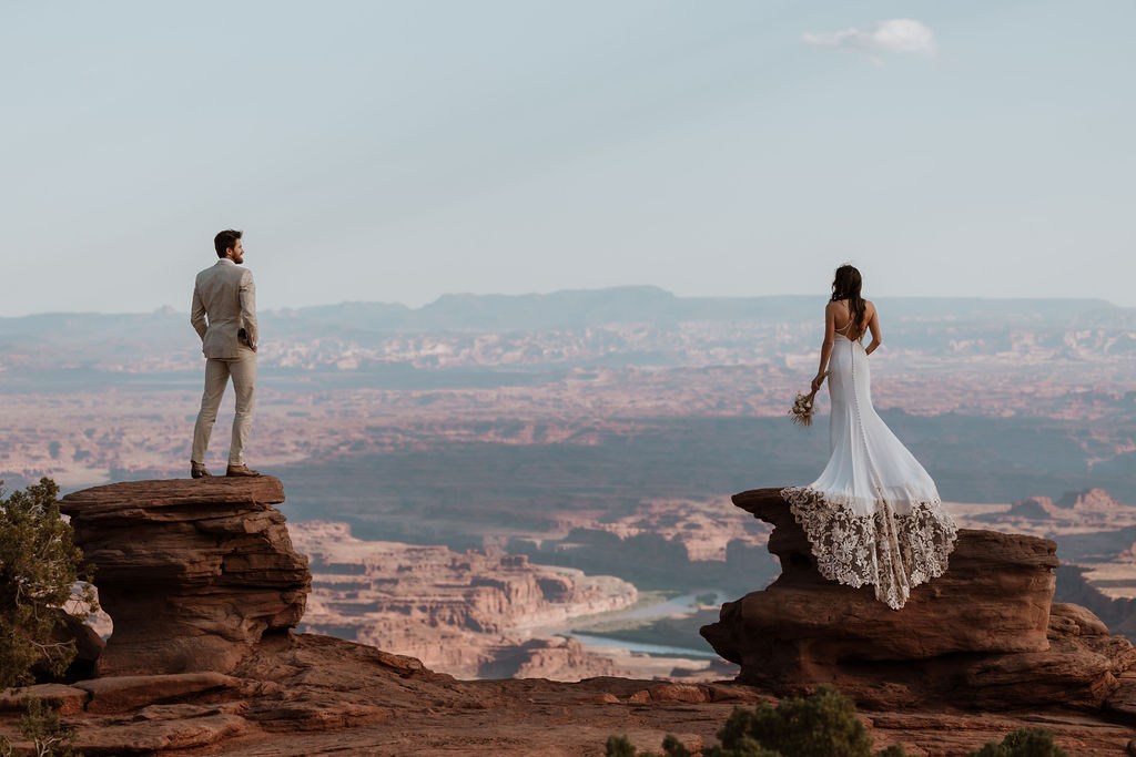 couple stands on rocks at Moab elopement