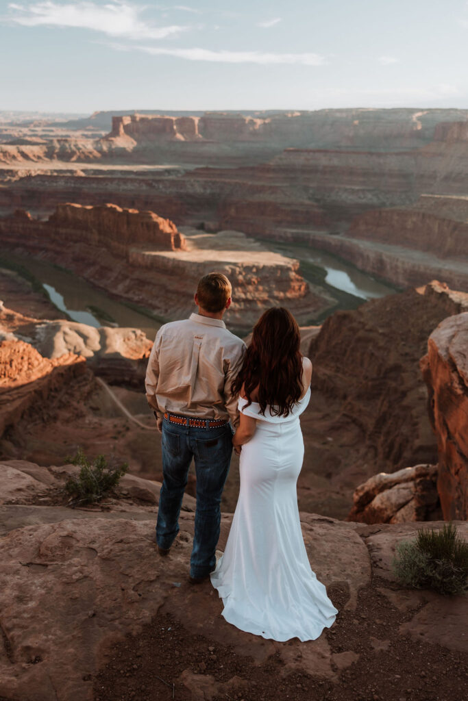 couple holds hands at Moab elopement