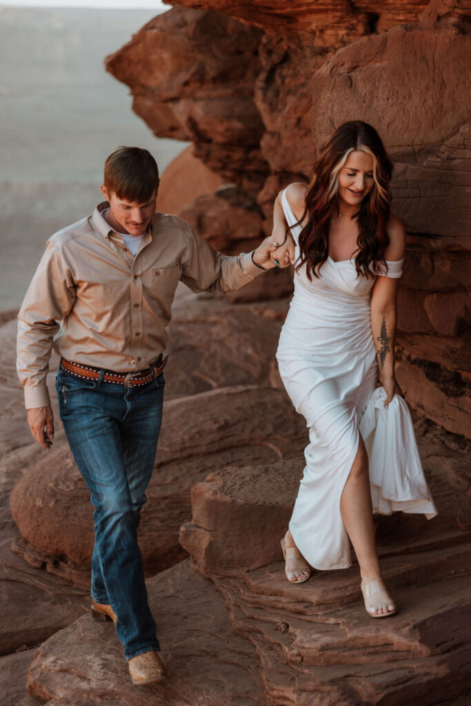 couple walks holding hands at Moab elopement