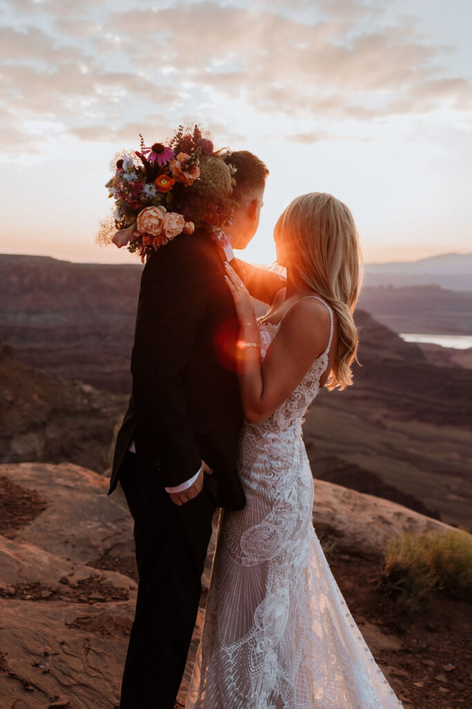 couple embraces during Moab elopement sunset