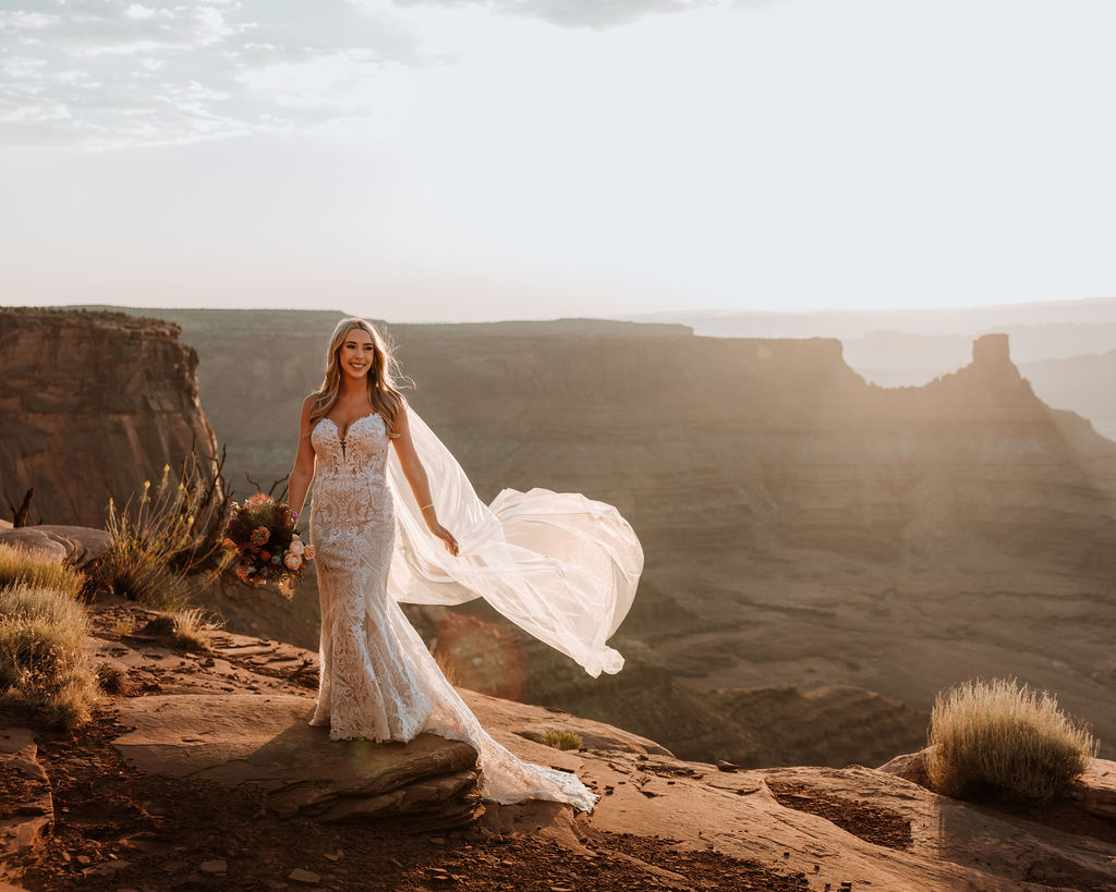 bride smiles at sunset Moab wedding overlook