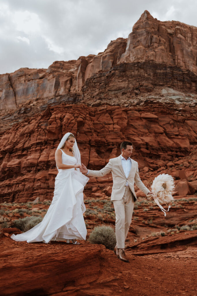 couple walks together at Moab elopement