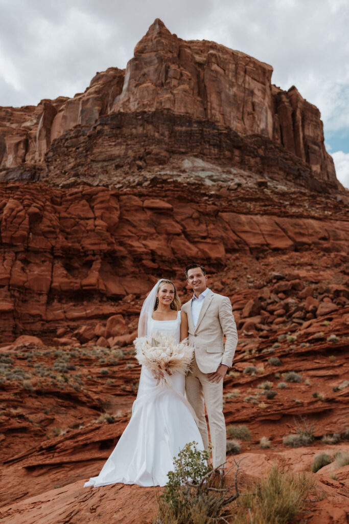 couple poses together at Moab elopement