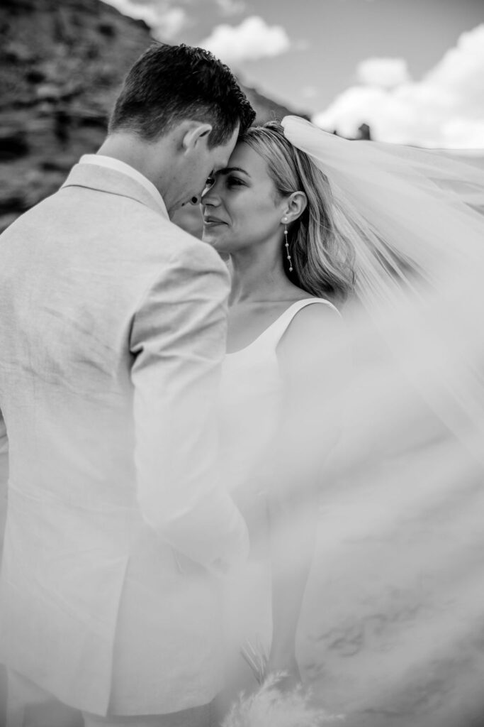 couple embraces at Moab elopement under veil