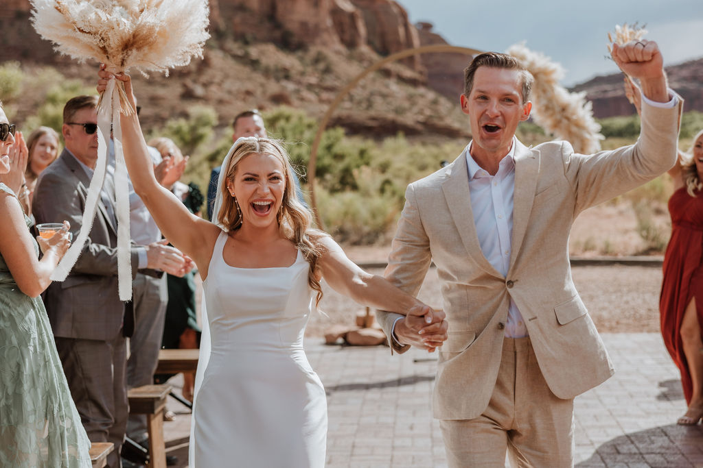 couple cheers together at Red Earth Venue wedding