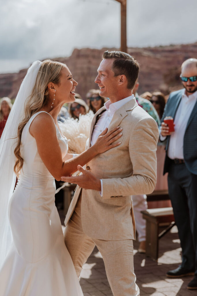 couple laughs together after wedding ceremony 