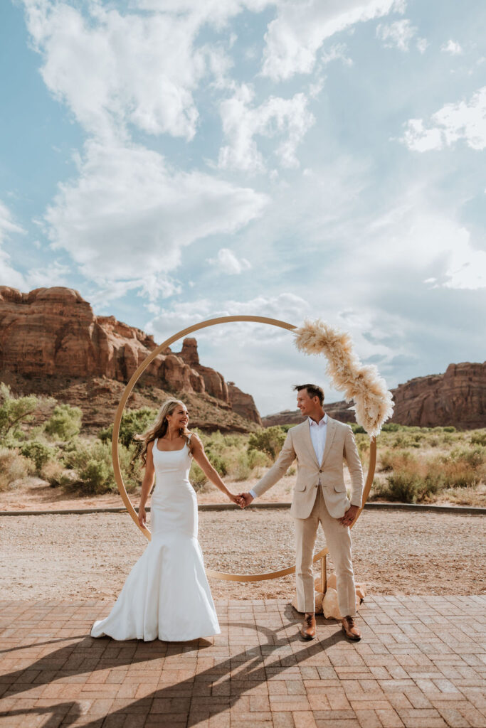 couple holds hands at Red Earth Venue wedding