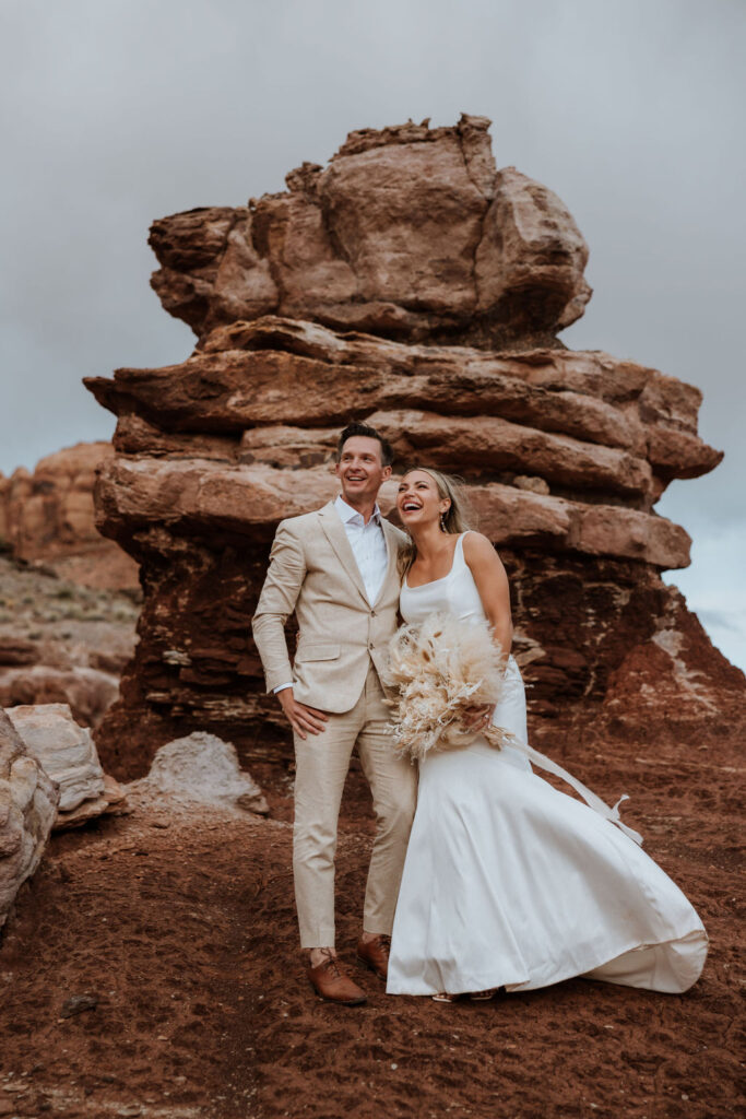 couple laughs together at Moab elopement