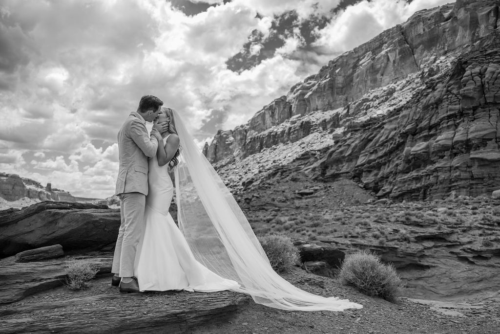 couple kisses at Moab desert elopement