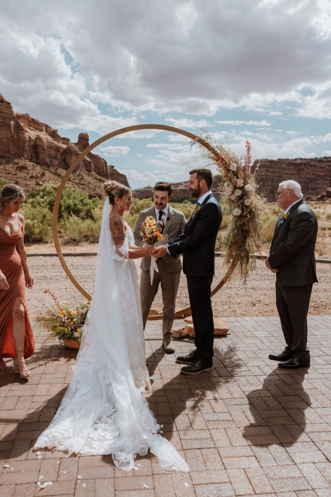 couple exchanges vows at the red earth venue moab wedding