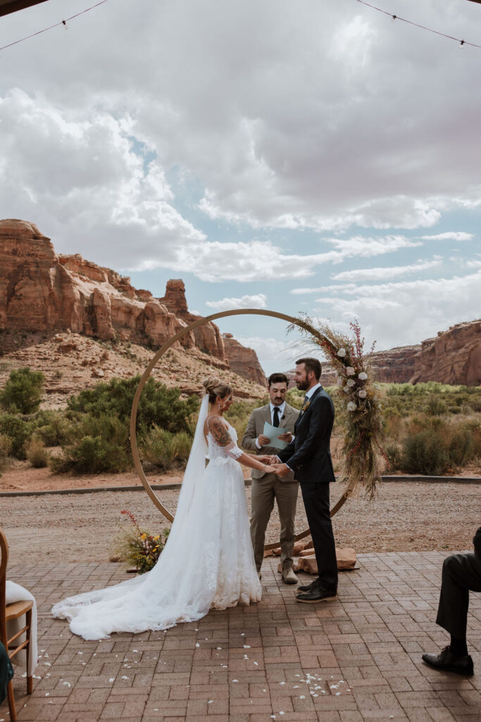 couple exchanges vows at the red earth venue moab wedding