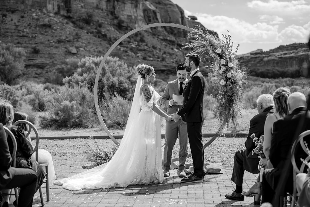 couple exchanges vows at the red earth venue moab wedding