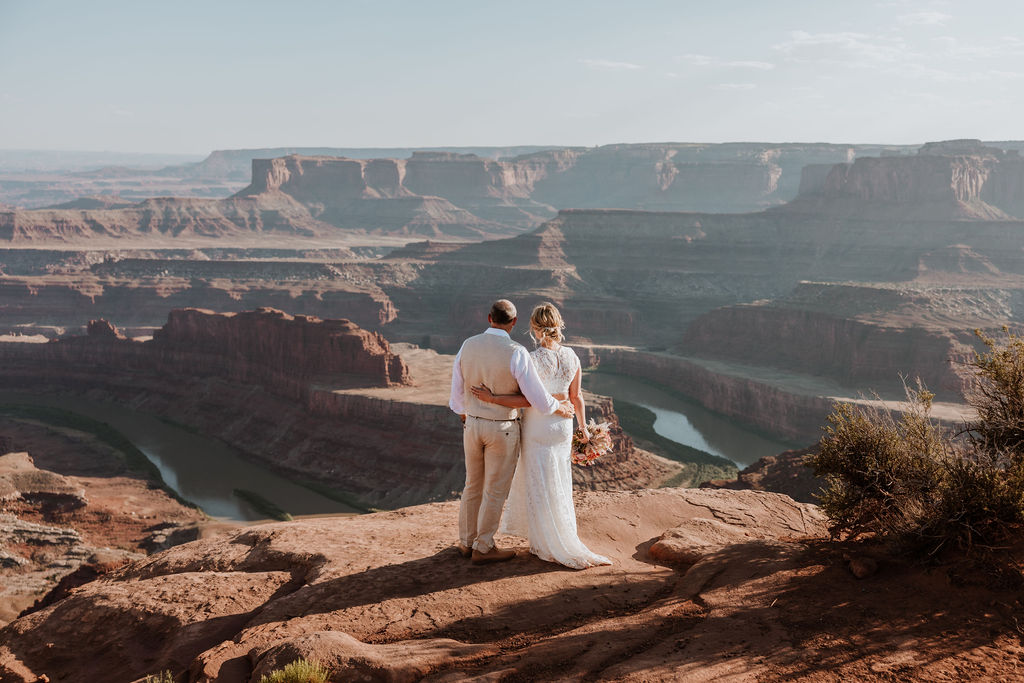 couple embraces at Moab elopement overlook