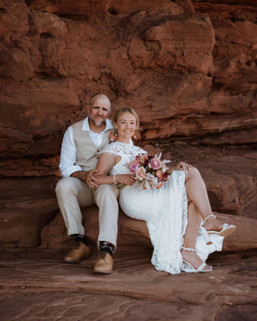 couple sits together at Moab wedding