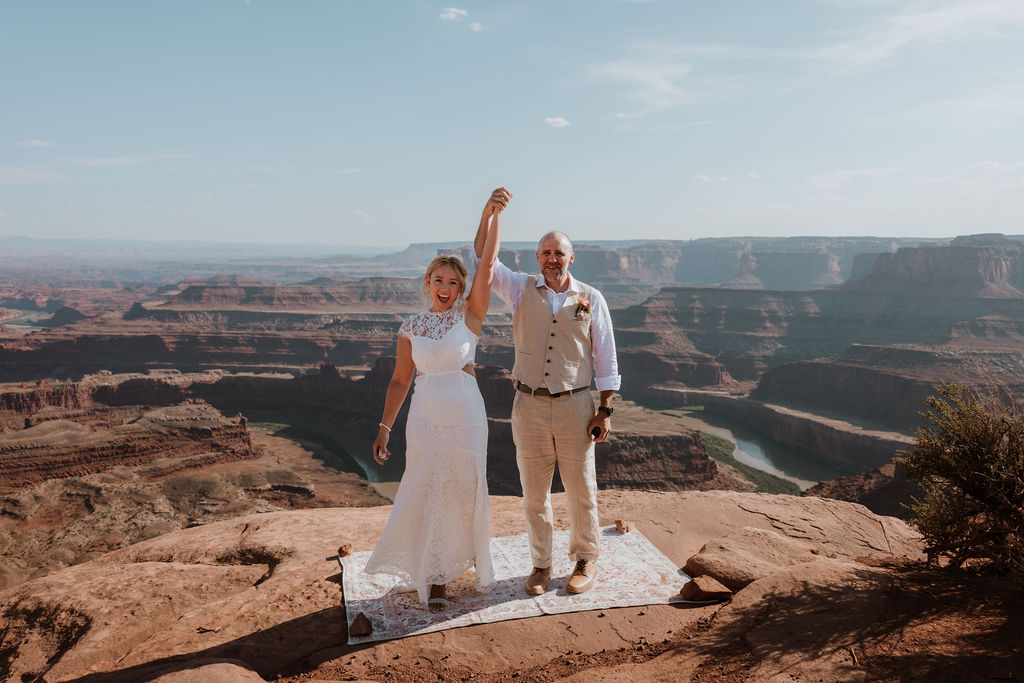 couple holds hands at Moab elopement ceremony