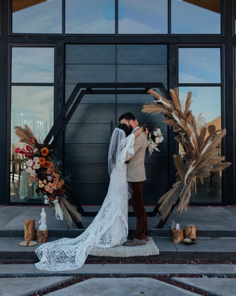 couple kisses during ceremony at Red Earth Venue wedding