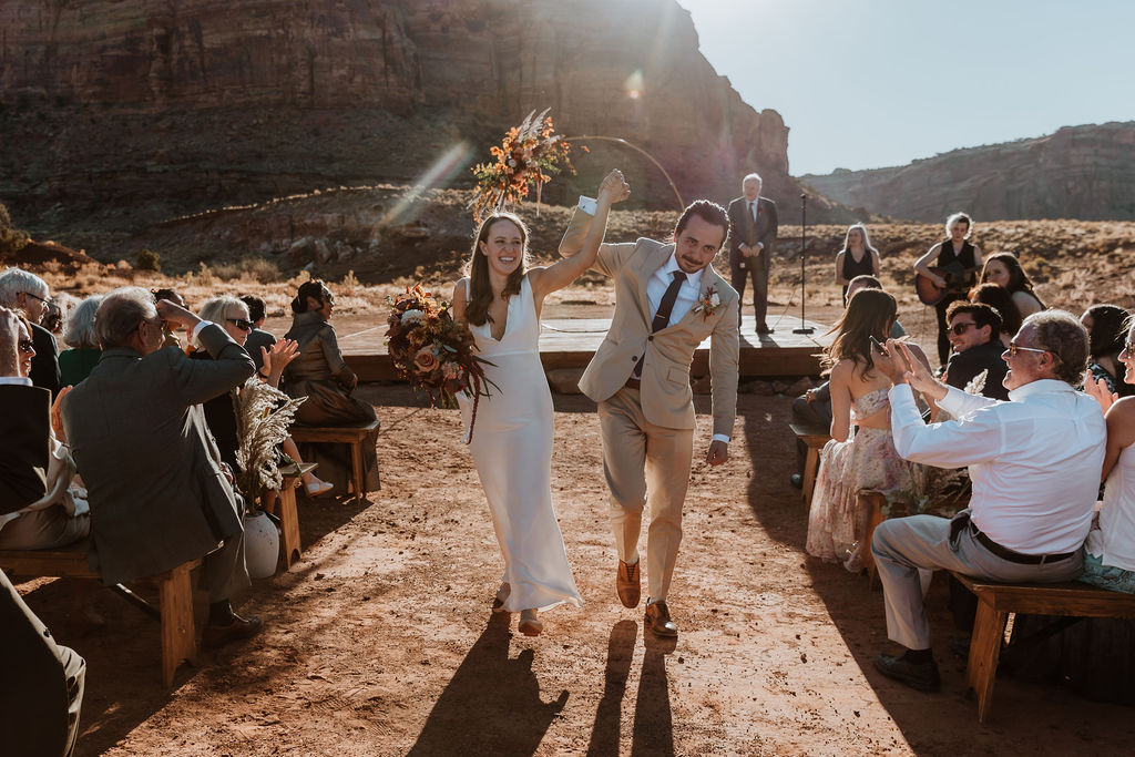 couple exits ceremony at Red Earth Venue wedding