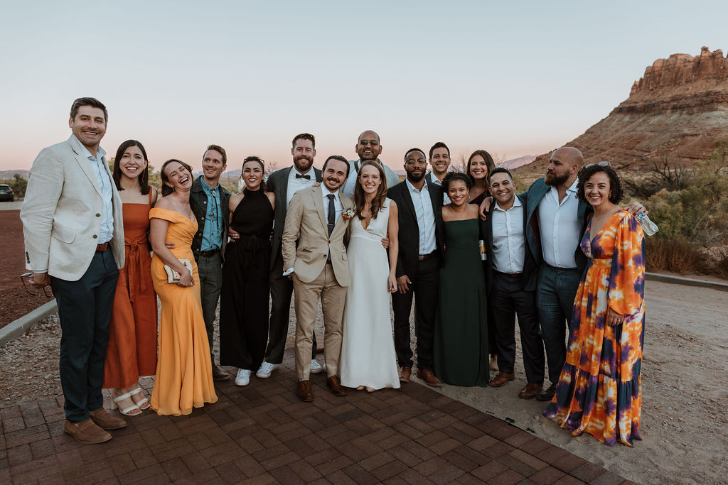 couple poses with wedding guests 