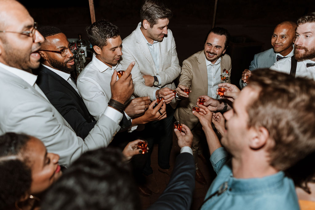 groom drinks shots with wedding party