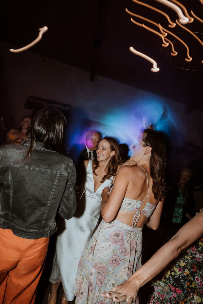 bride dances with wedding guest during wedding reception