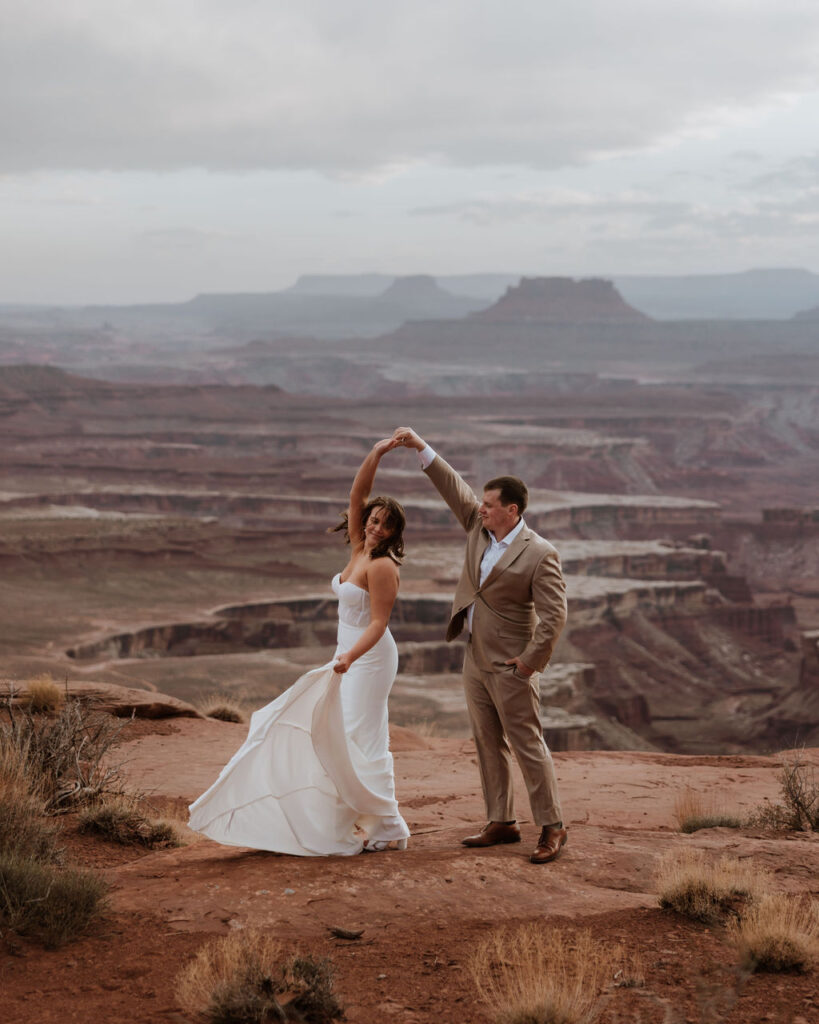 groom twirls bride at Canyonlands elopement