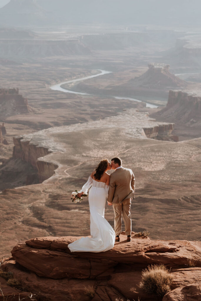 couple kisses at Canyonlands National Park elopement overlook