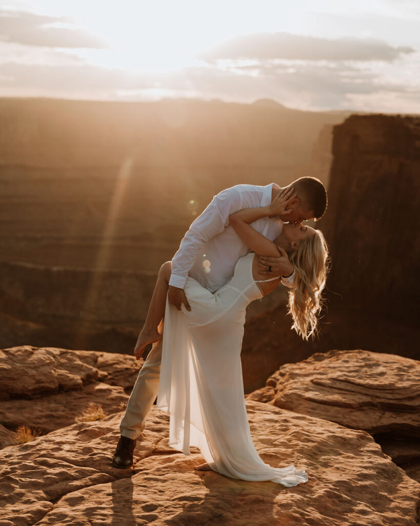 couple kisses at Dead Horse State Park sunset elopement