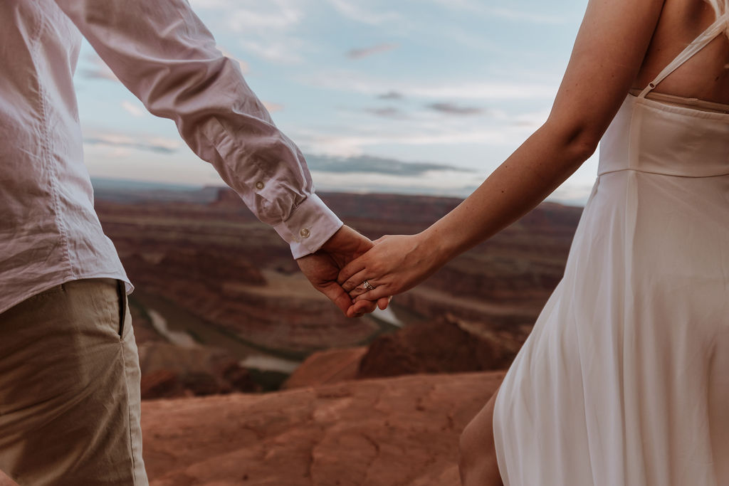 couple holds hands at Moab elopement