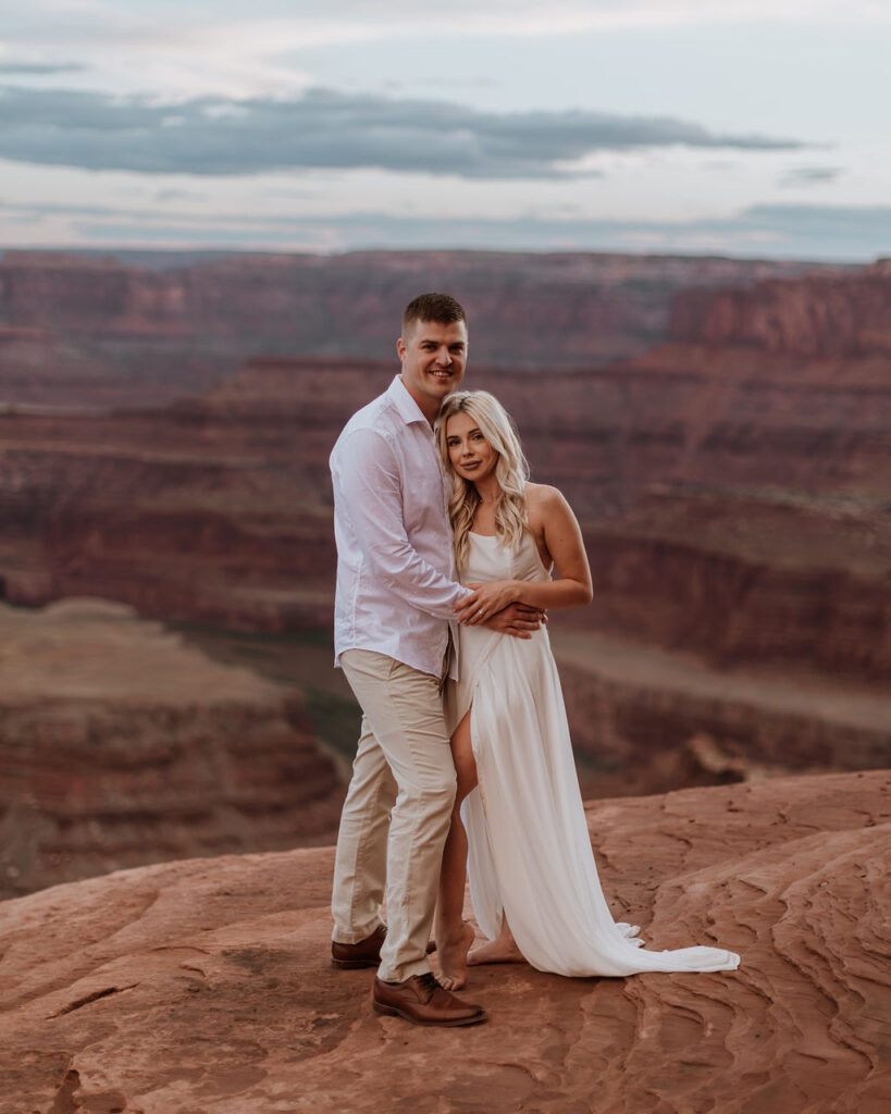 couple embraces at Dead Horse Point State Park elopement