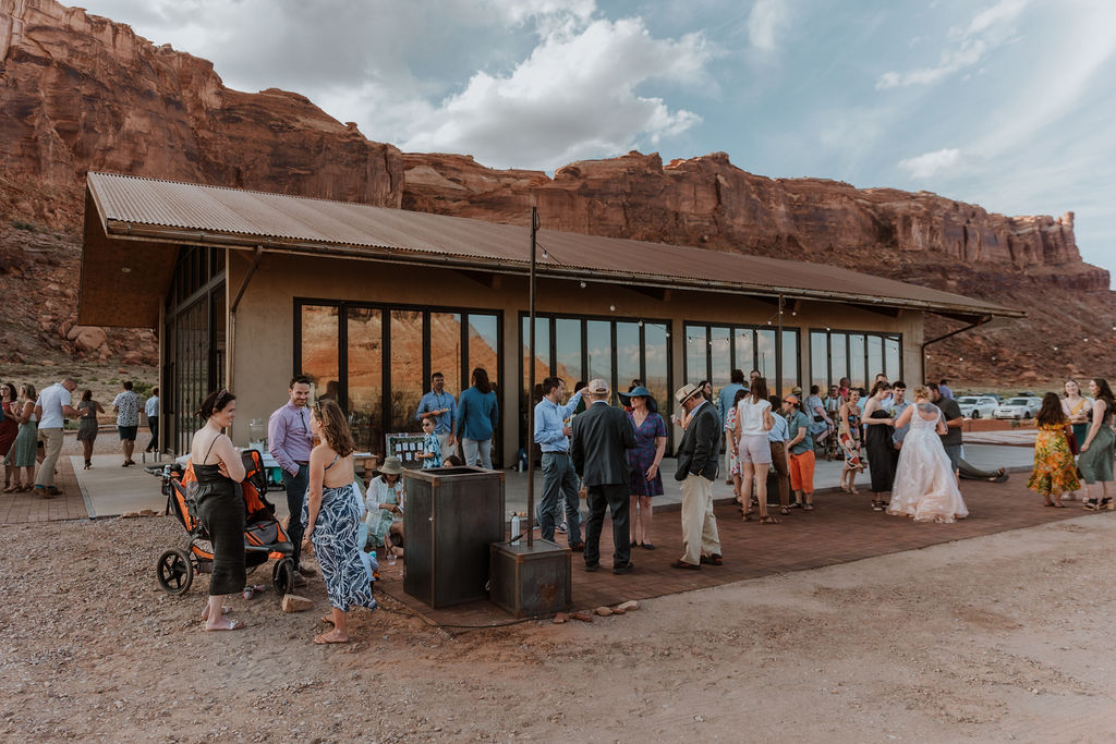 couple has cocktail hour with guest at the Red Earth Venue wedding